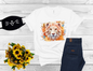 image of a short sleeve, white, graphic tee, with 3d flowers and a lion